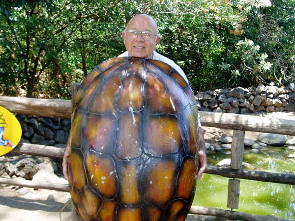 image of Alvaro behind a large tortoise shell